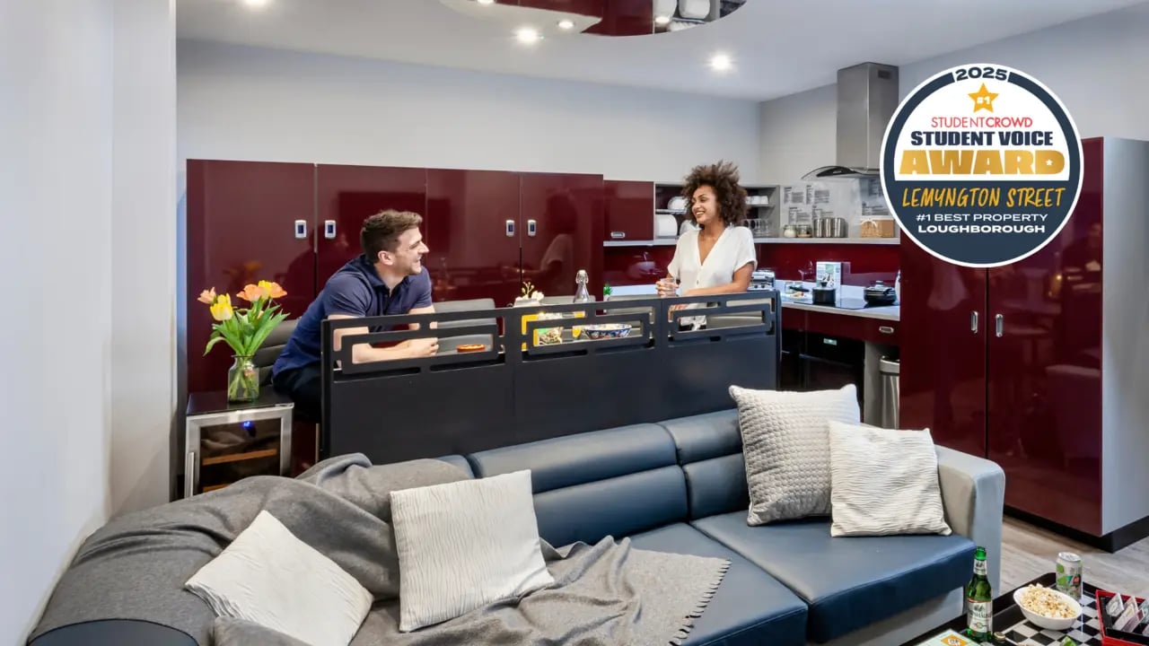 Modern living room with sectional couch and kitchen living area at Study Inn Loughborough - Lemyngton Street in Loughborough Student Accommodation