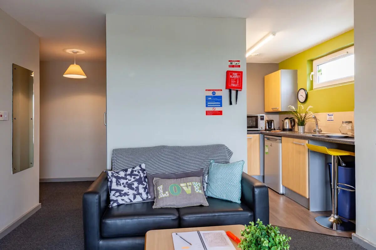 Sofa kitchen area with appliances and seating living room at Filbert Village in Leicester Student Accommodation