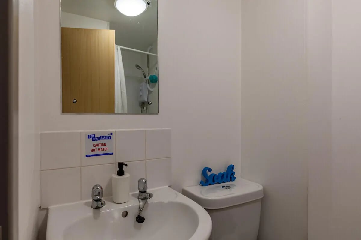 Sink toilet mirror shower curtain bathroom at Filbert Village in Leicester Student Accommodation