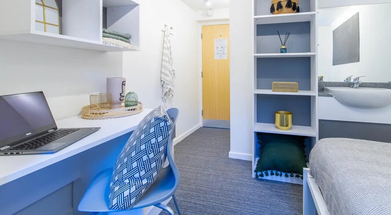 Desk laptop chair shelves bed sink bathroom study area at Green Wood Court in Southampton Student Accommodation