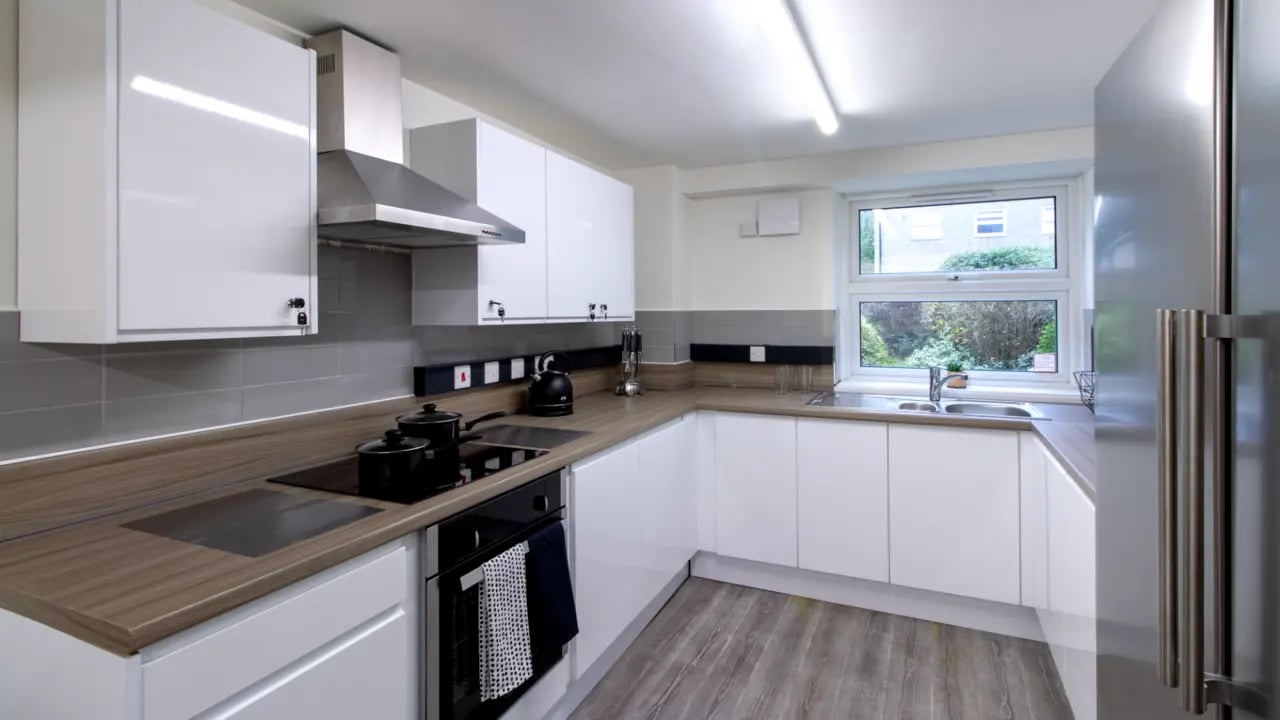 Modern white cabinets sink and oven kitchen at Green Wood Court in Southampton Student Accommodation