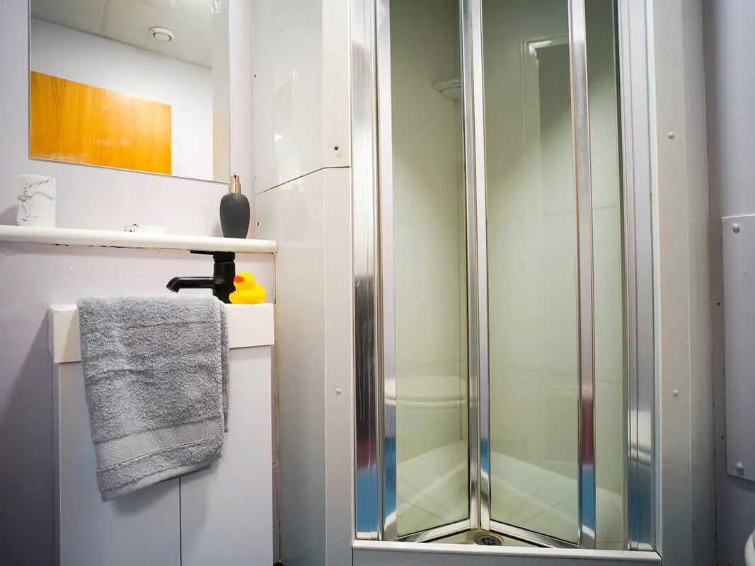 Sink towel dispenser rubber duck shower stall bathroom at 8 Roxburgh in Edinburgh Student Accommodation