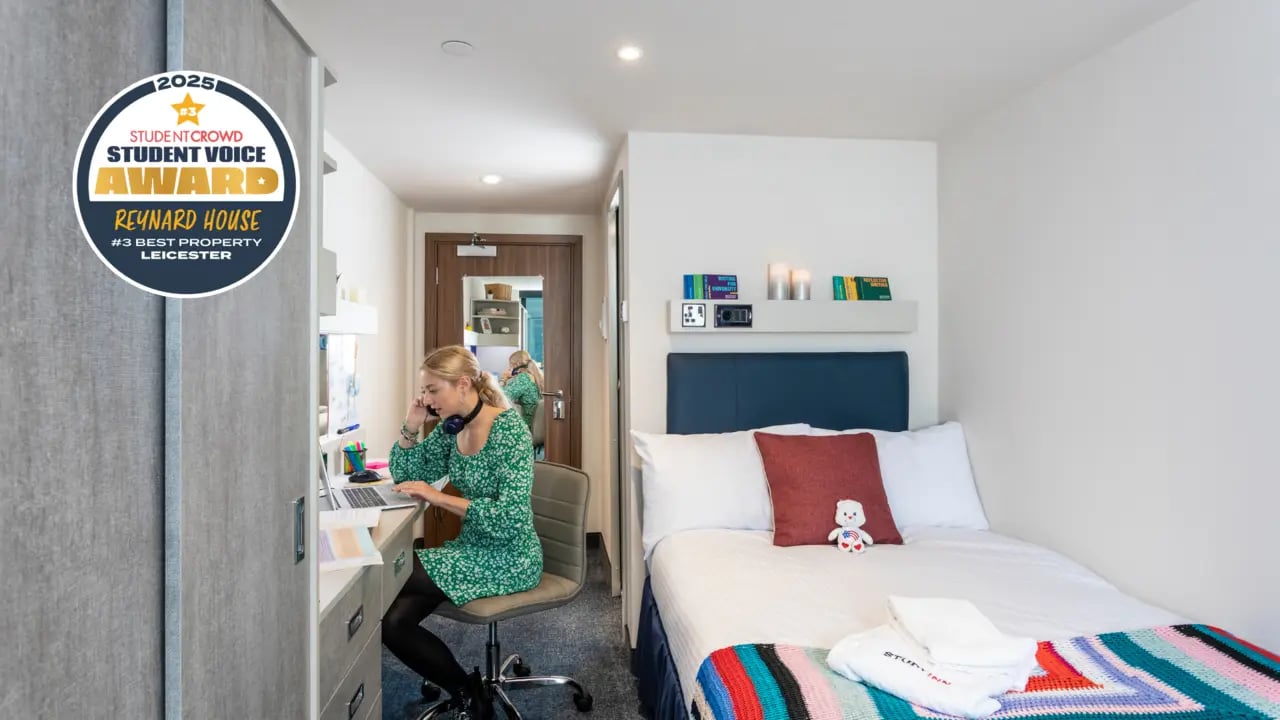 Woman at desk and bed student room bedroom at Reynard House in Leicester Student Accommodation