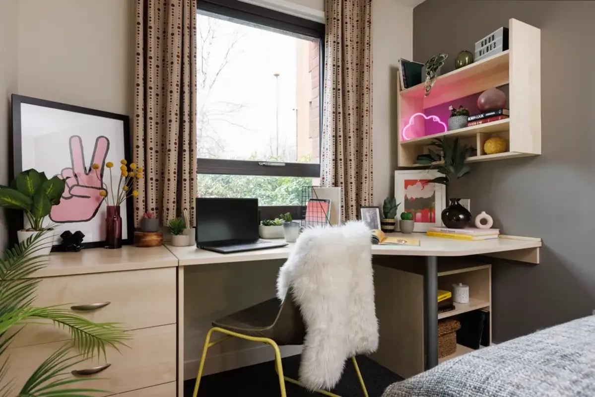 Desk with laptop and artwork study area at The Anvil in Sheffield Student Accommodation