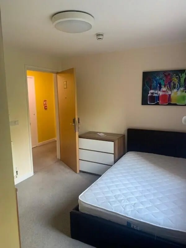Bed mattress dresser doorway colorful art bedroom at Canterbury Student Village in Canterbury Student Accommodation