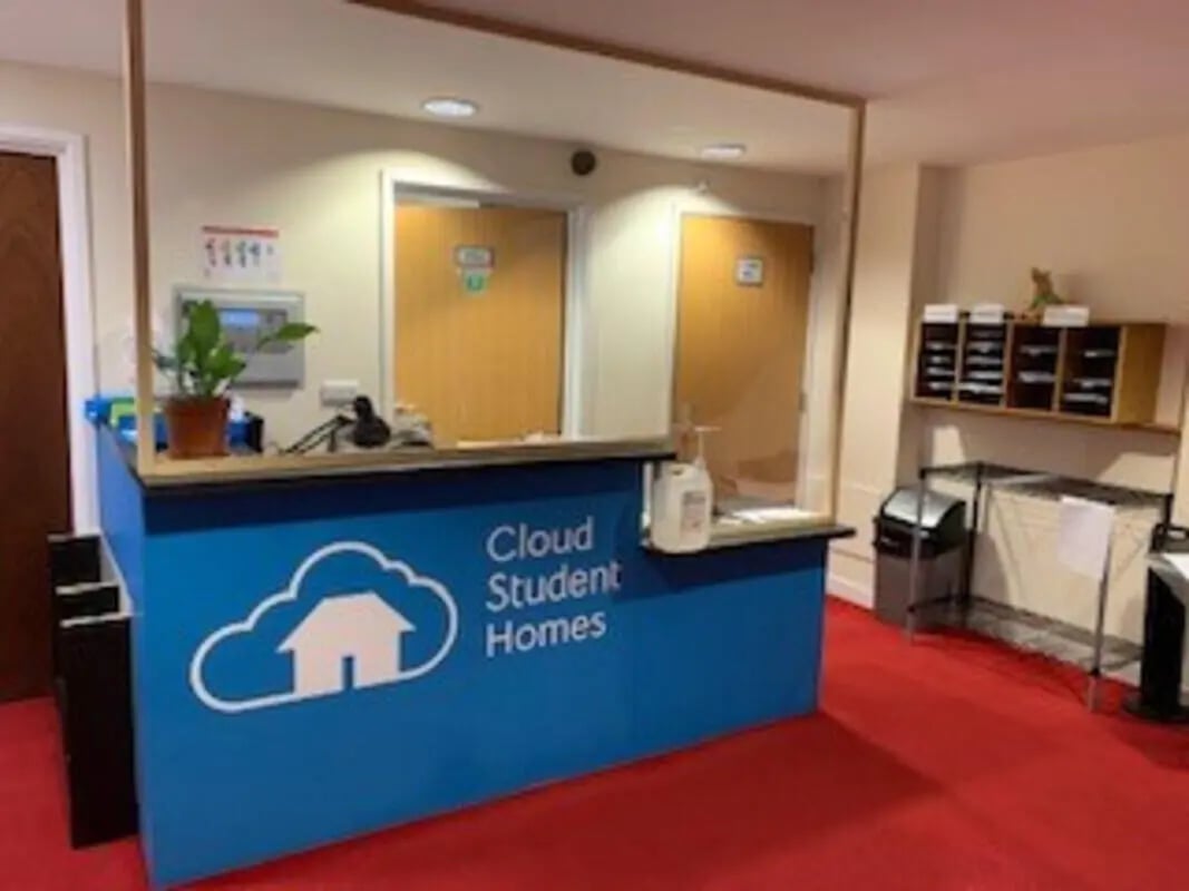 Reception desk with plant and hand sanitizer lobby at Canterbury Student Village in Canterbury Student Accommodation