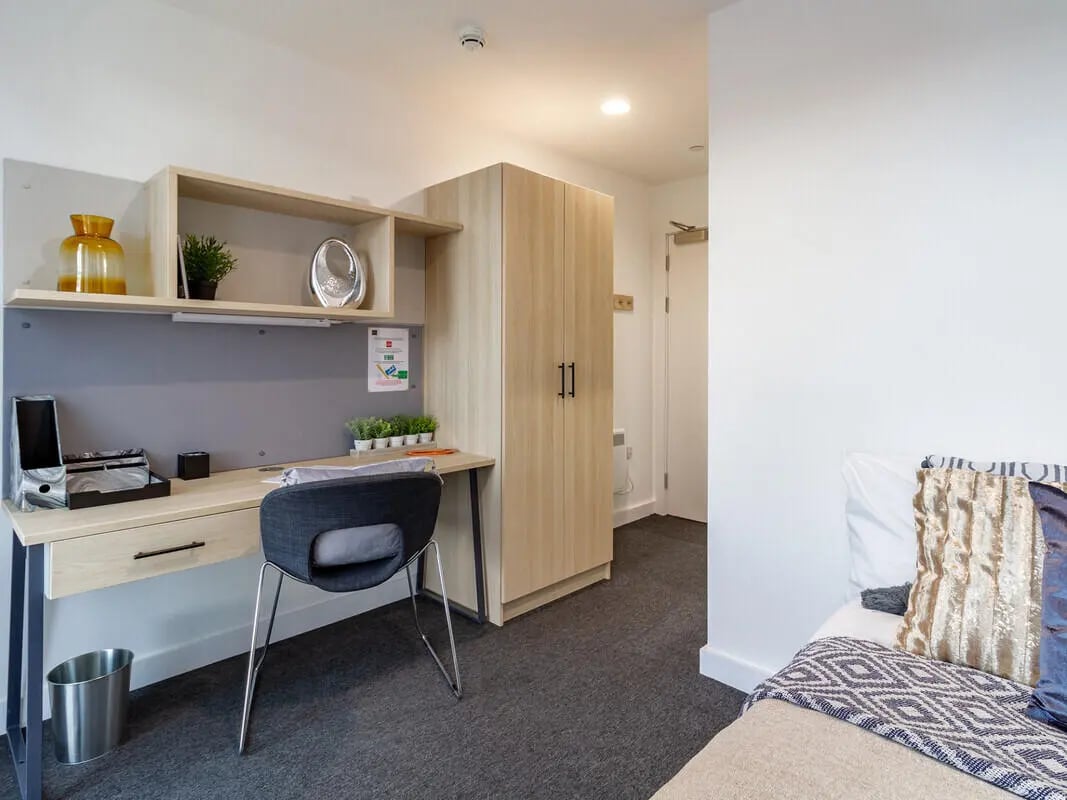 Desk chair shelves wardrobe and bed bedroom at Straits Village in Nottingham Student Accommodation