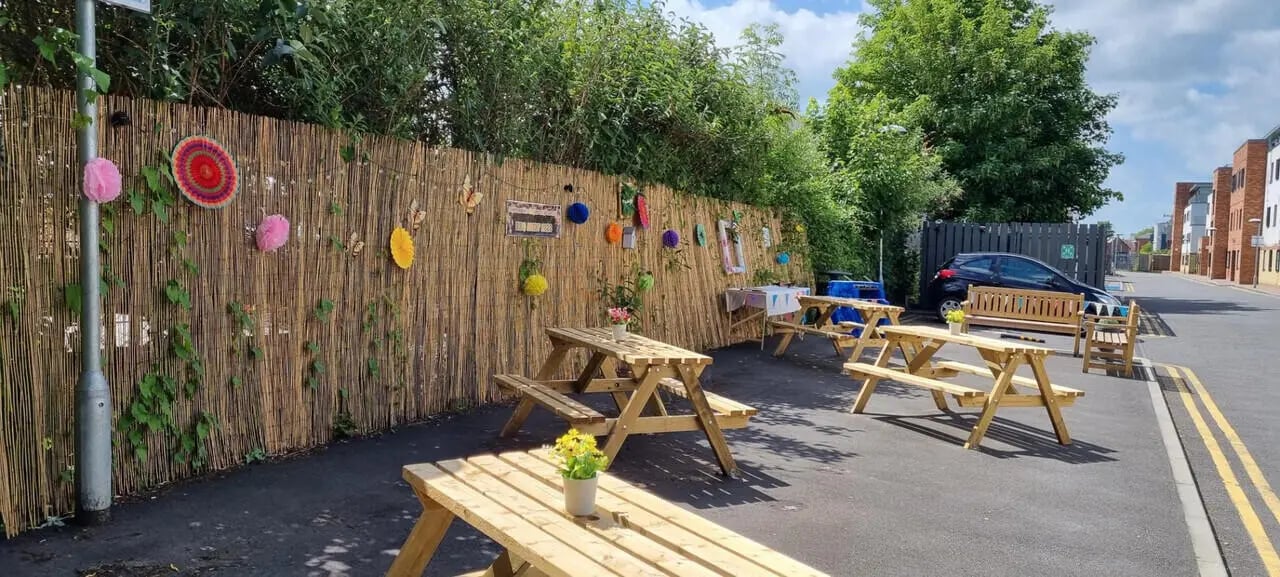 Wooden picnic tables decorated wall exterior at Canterbury Student Village in Canterbury Student Accommodation