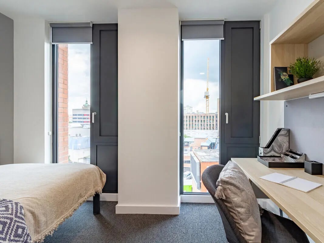 Bed desk chair and city view bedroom at Straits Village in Nottingham Student Accommodation