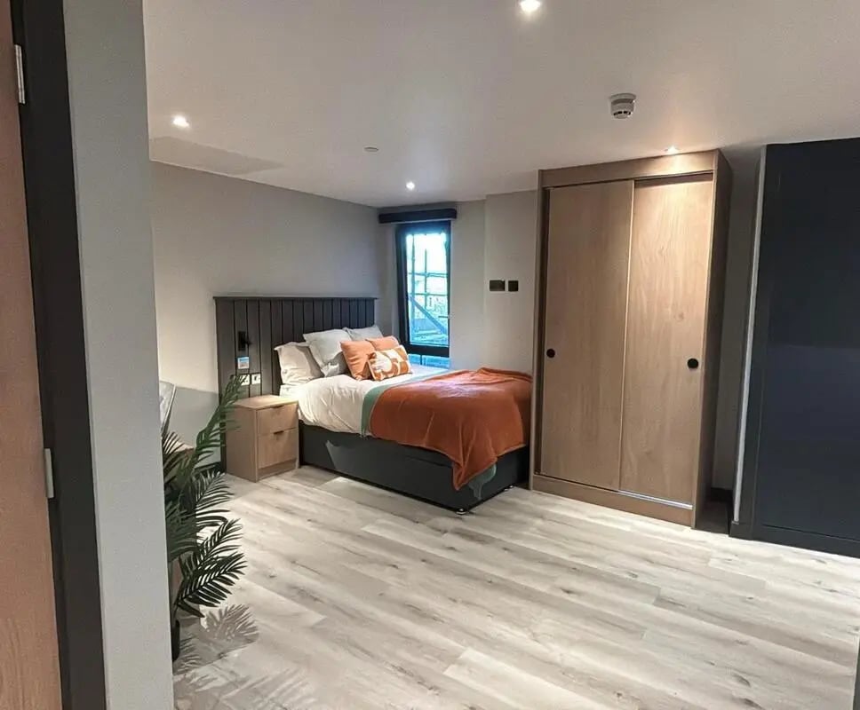 Bed bedside table plant wardrobe bedroom at Arcadian in Nottingham Student Accommodation