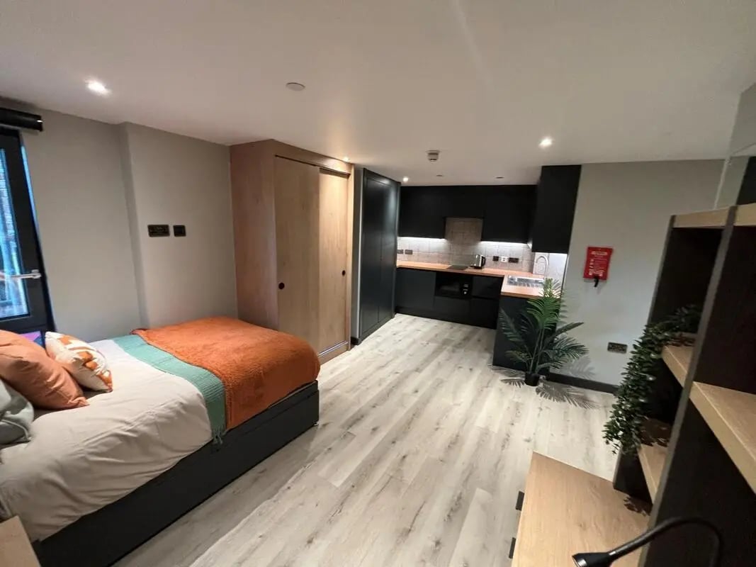 Bed wardrobe and modern kitchen studio apartment at Arcadian in Nottingham Student Accommodation