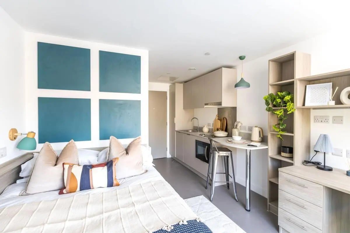 Bed kitchen counter and shelves student studio at Timber Yard in Bristol Student Accommodation