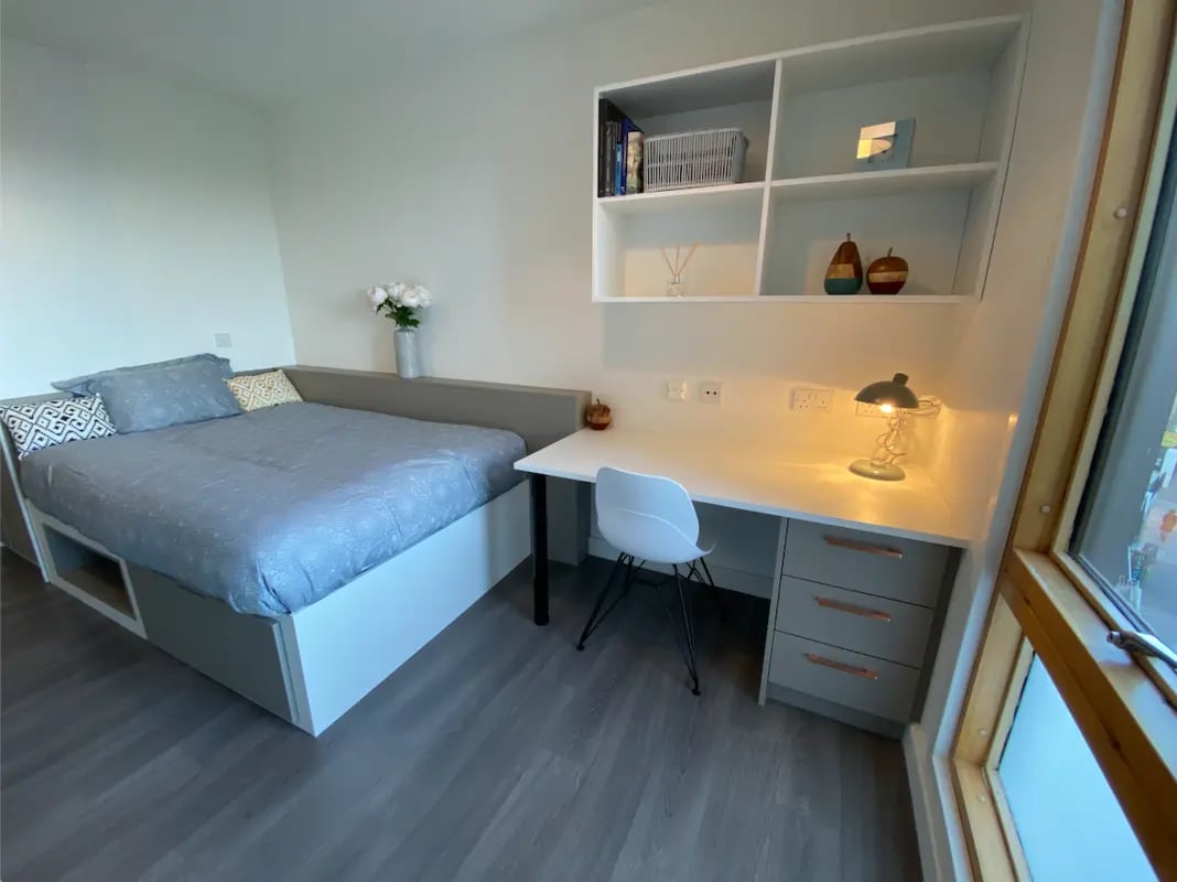 Bed desk shelves and vase bedroom at Charles Morton Court in London Student Accommodation