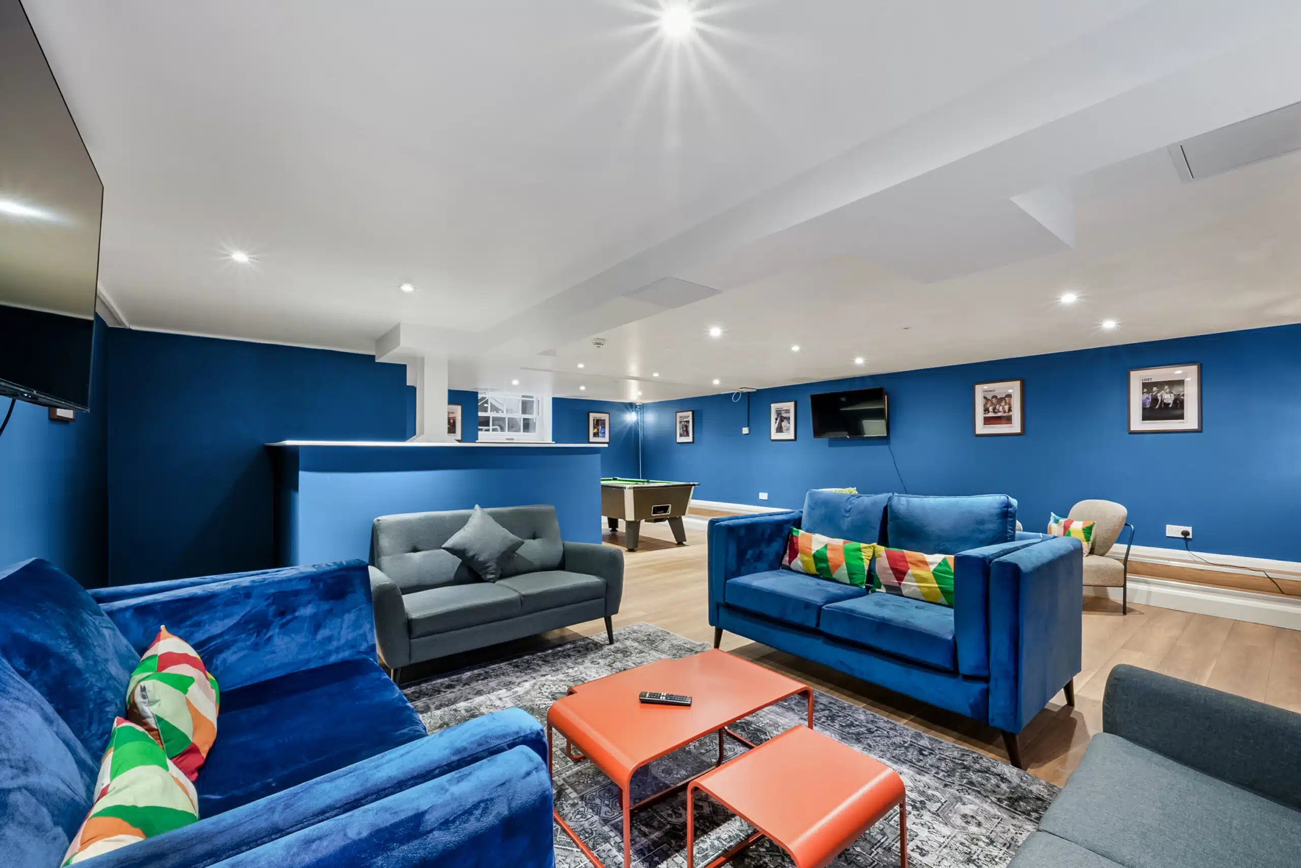 Blue sofas pool table and coffee table living room at AXO Waterloo in London Student Accommodation