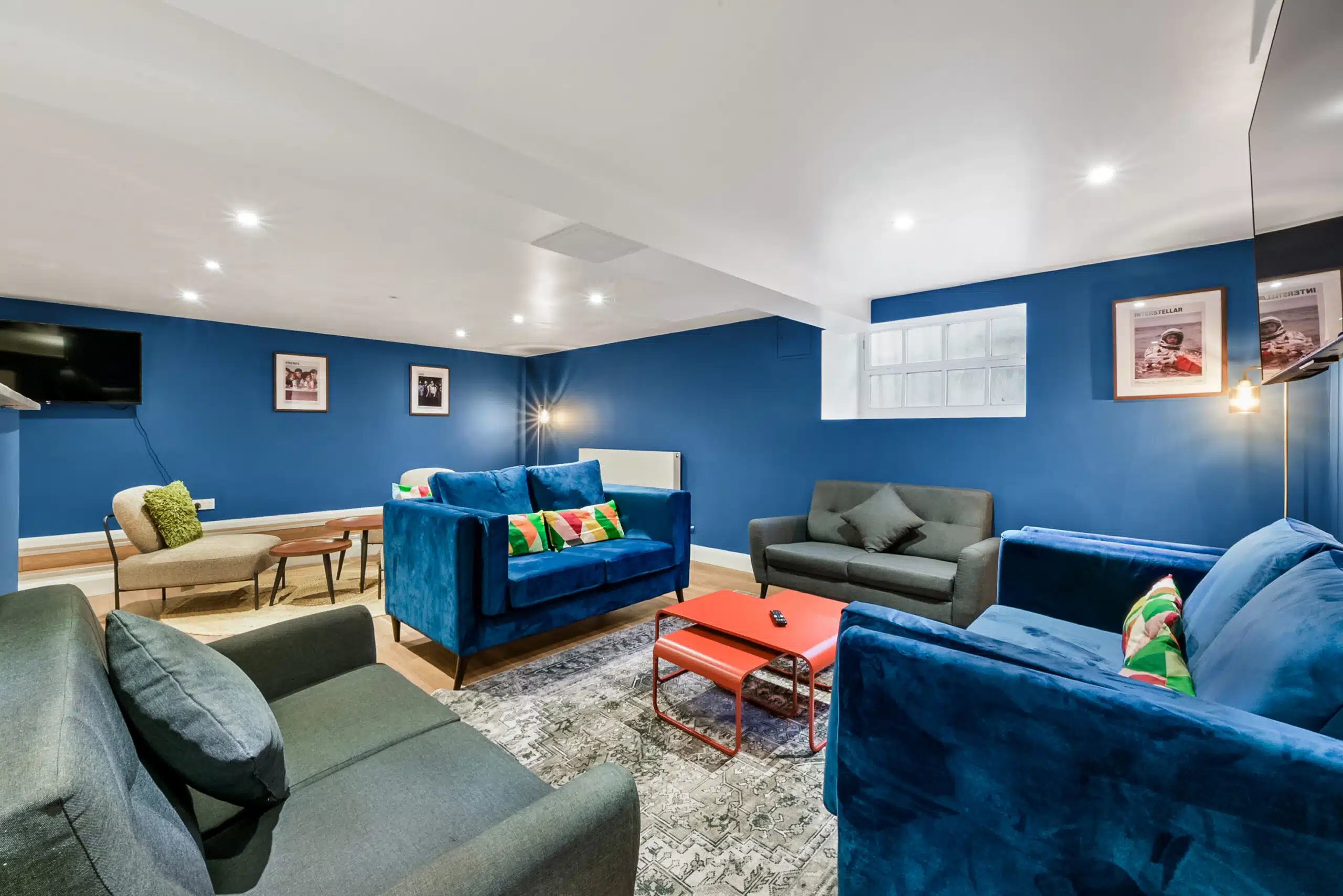 Blue velvet sofas and grey sofa living room at AXO Waterloo in London Student Accommodation