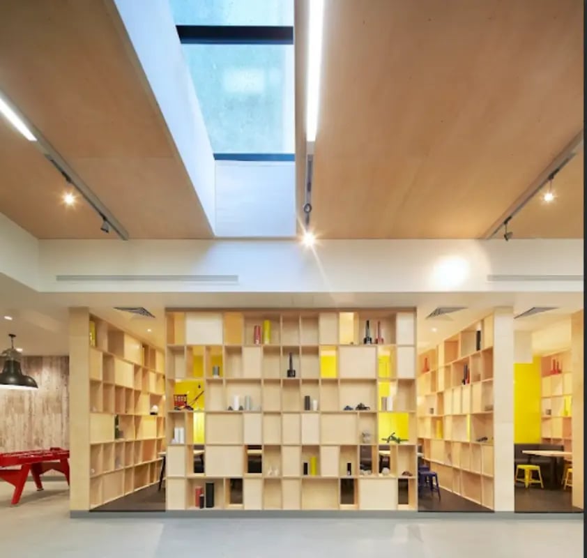 Shelving units with items and red foosball table common area at Spring Mews in London Student Accommodation