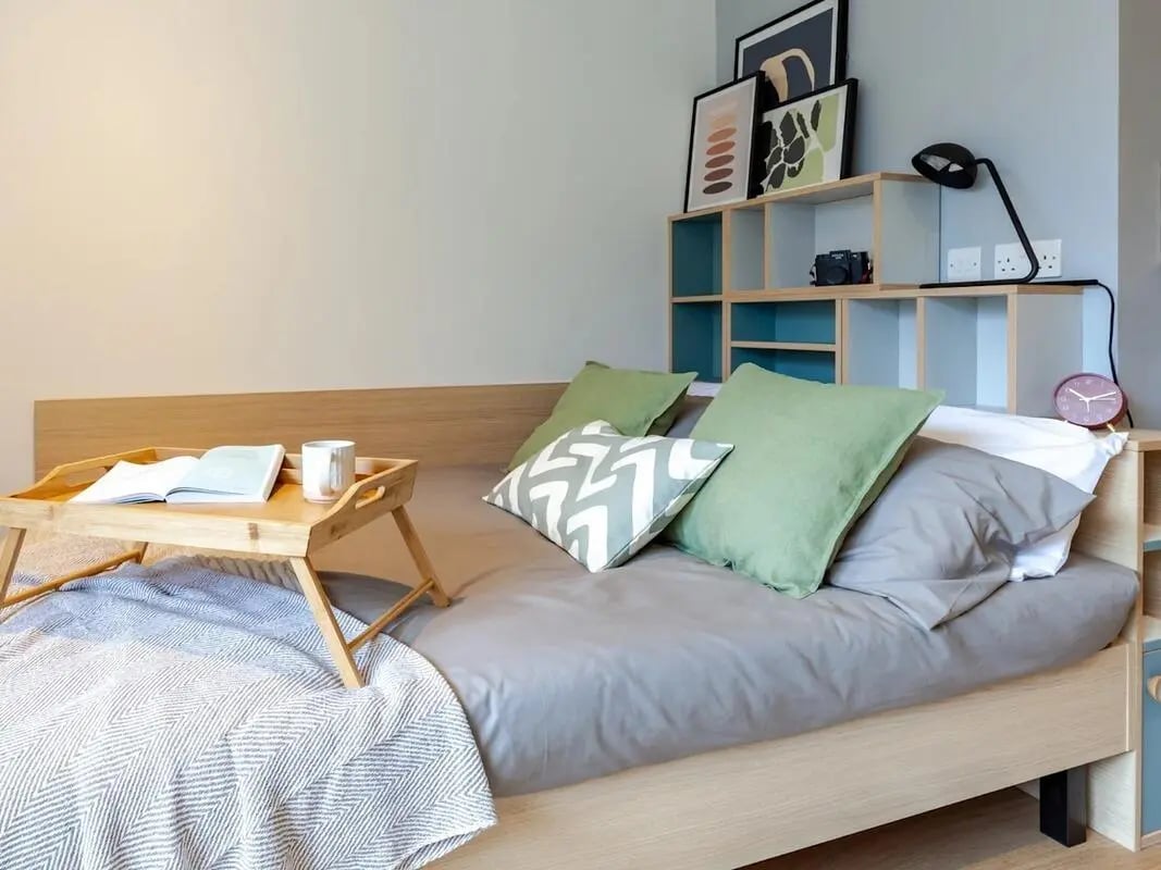 Bed with tray book mug and pillows bedroom at The Gorge in Exeter Student Accommodation