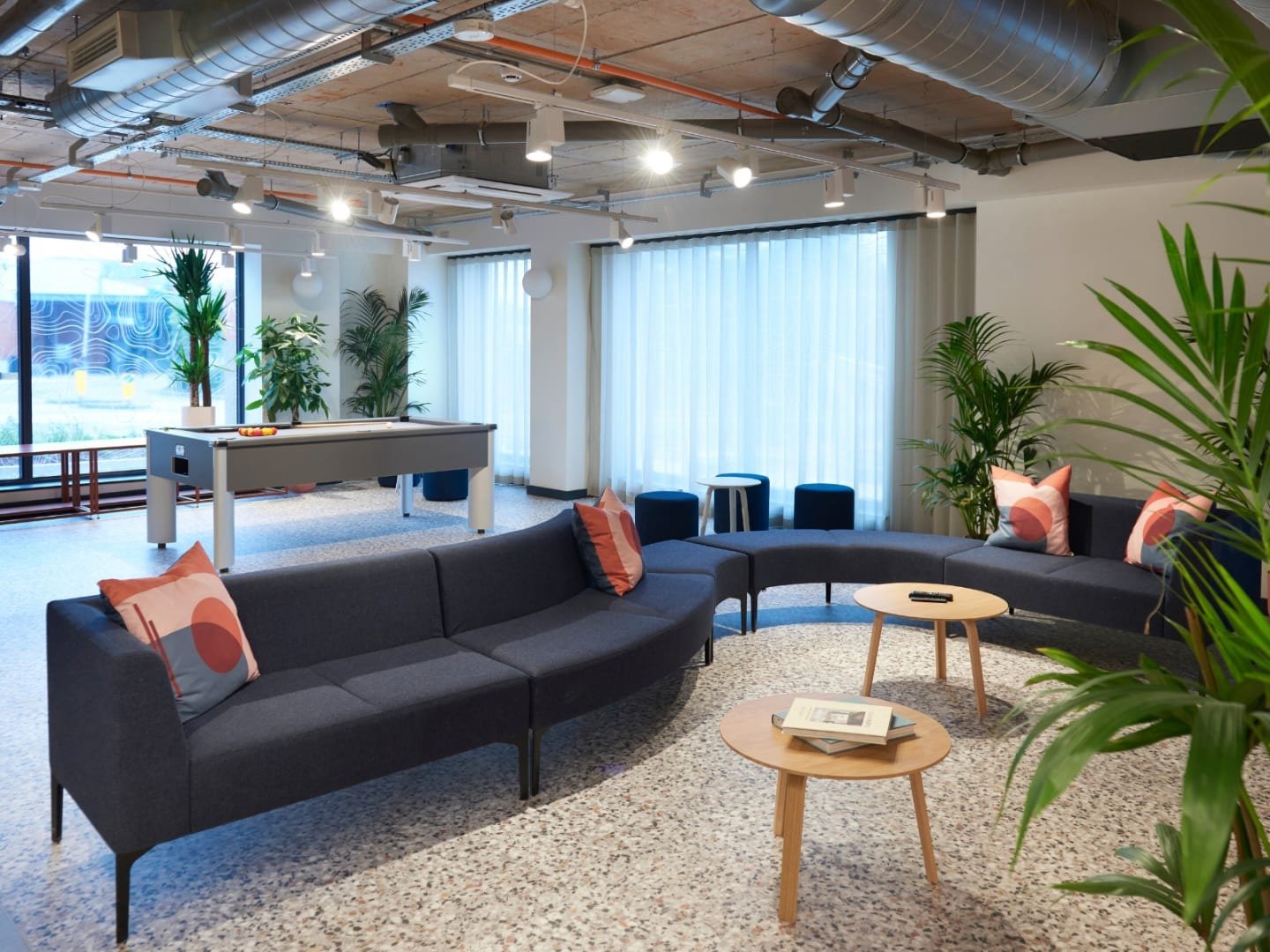 Pool table couches coffee tables plants communal area at The Gorge in Exeter Student Accommodation