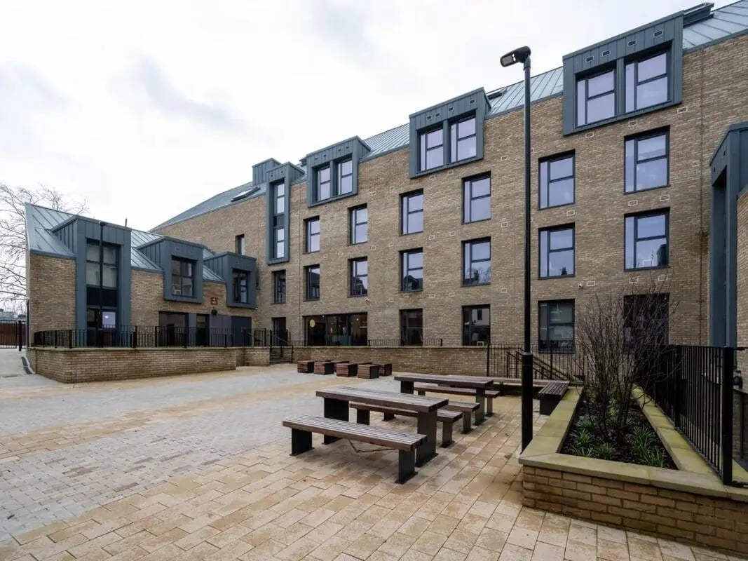 Courtyard with picnic tables and buildings exterior at The Gorge in Exeter Student Accommodation