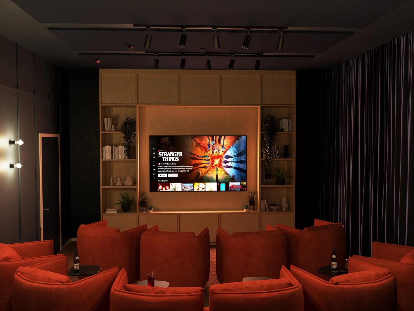 Orange recliners facing large screen entertainment living room at Venti House in London Student Accommodation