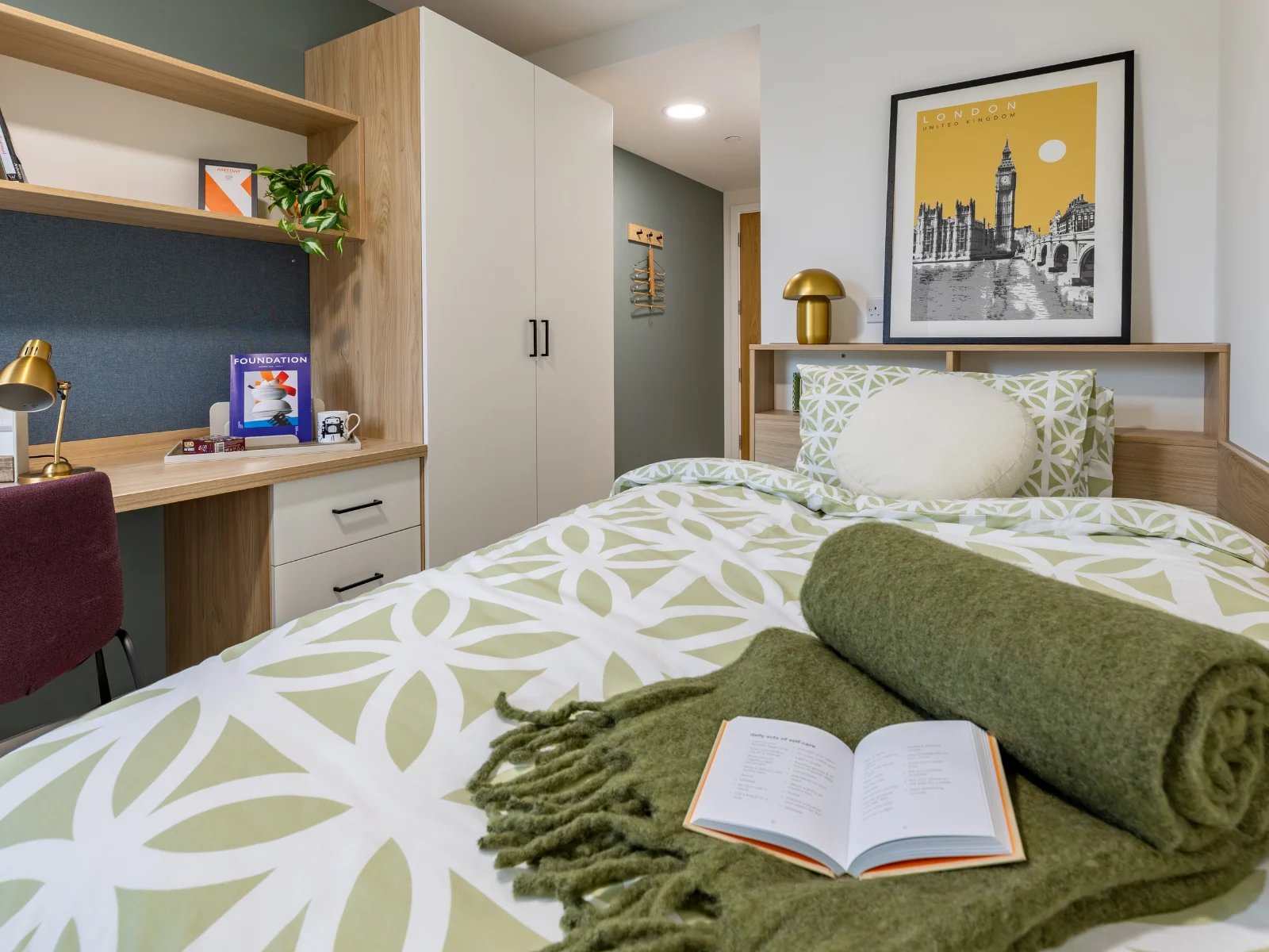 Desk lamp bedding London poster and wardrobe bedroom at Venti House in London Student Accommodation