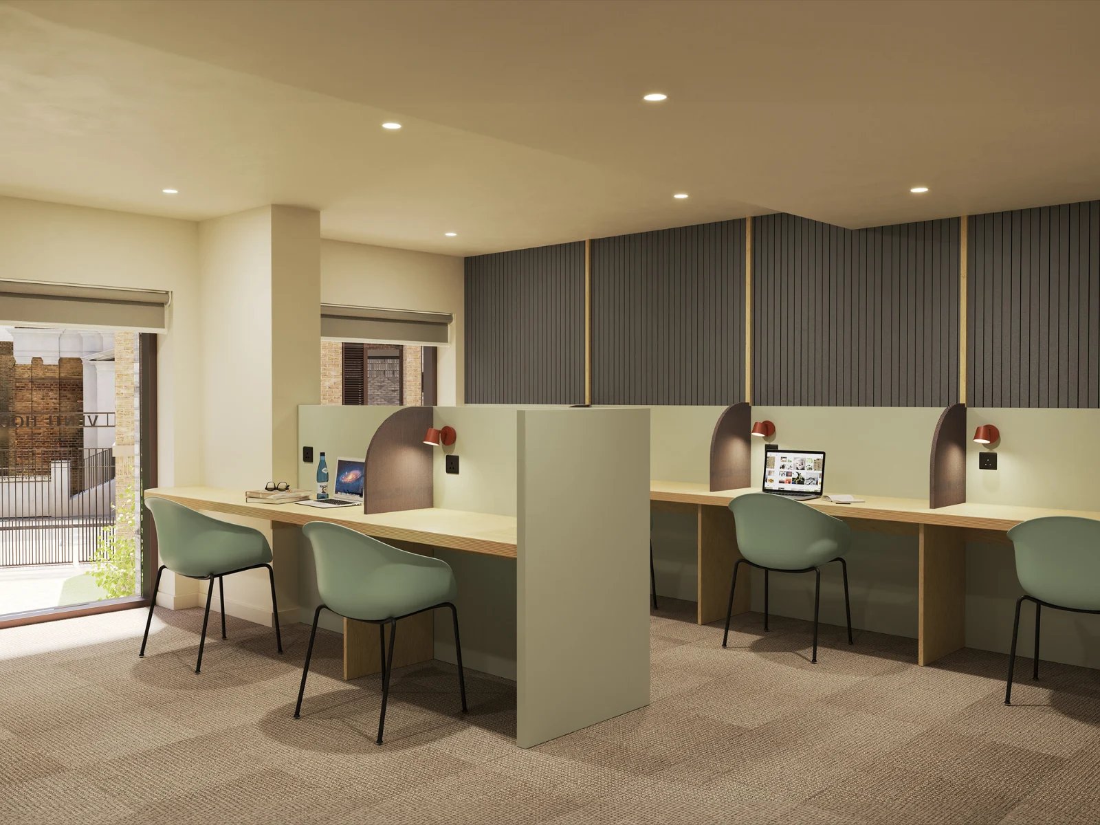 Desks with chairs laptops and lamps study area at Venti House in London Student Accommodation