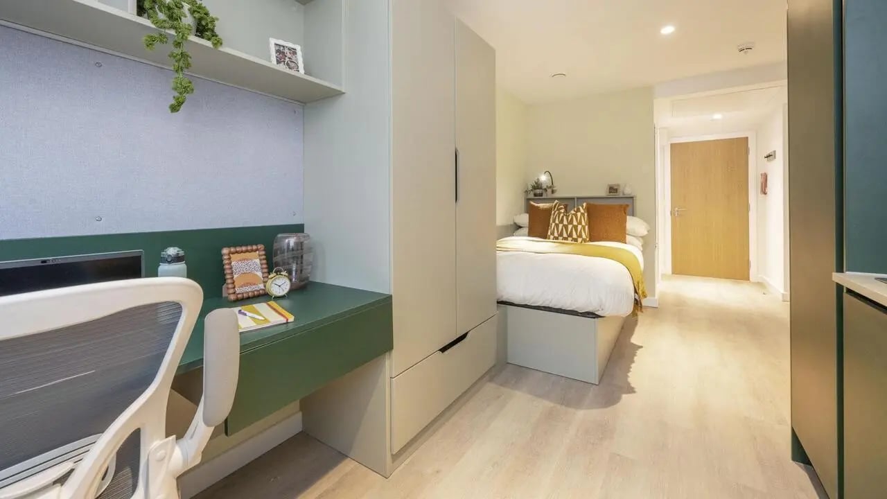 Desk bed wardrobe and door bedroom living room at St Vincent Studios in Glasgow Student Accommodation