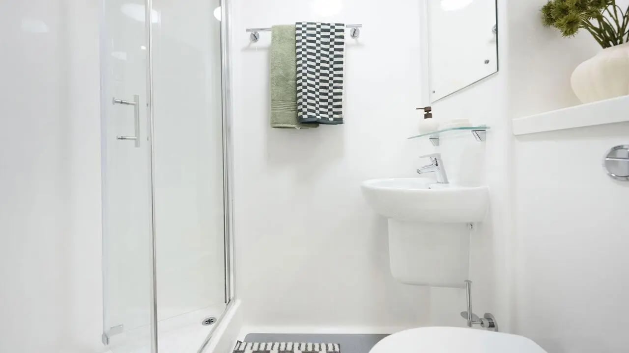 Shower sink mirror soap dispenser towels bathroom at St Vincent Studios in Glasgow Student Accommodation