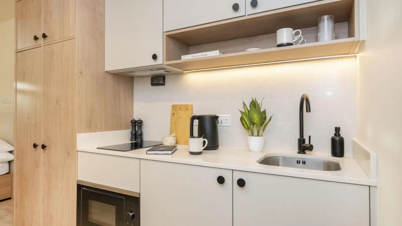 Modern kitchen with kettle sink and cabinets kitchen at Press House in London Student Accommodation