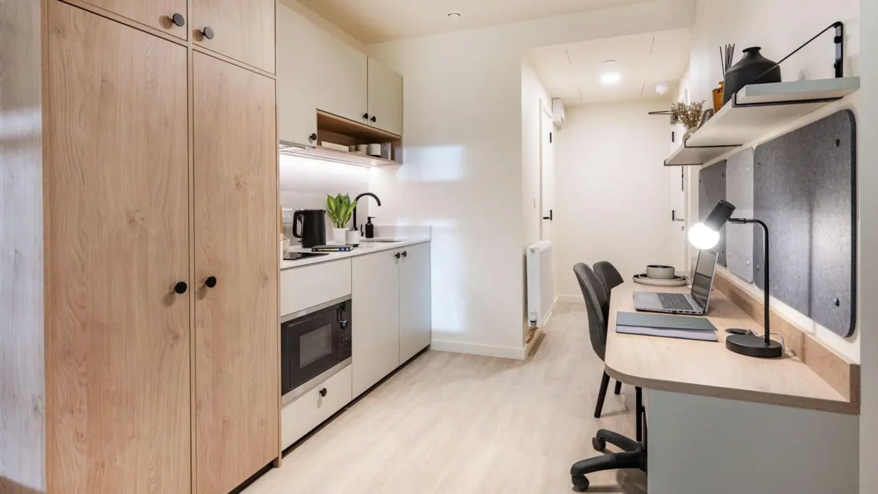 Wardrobe kitchen desk with laptop study area at Press House in London Student Accommodation