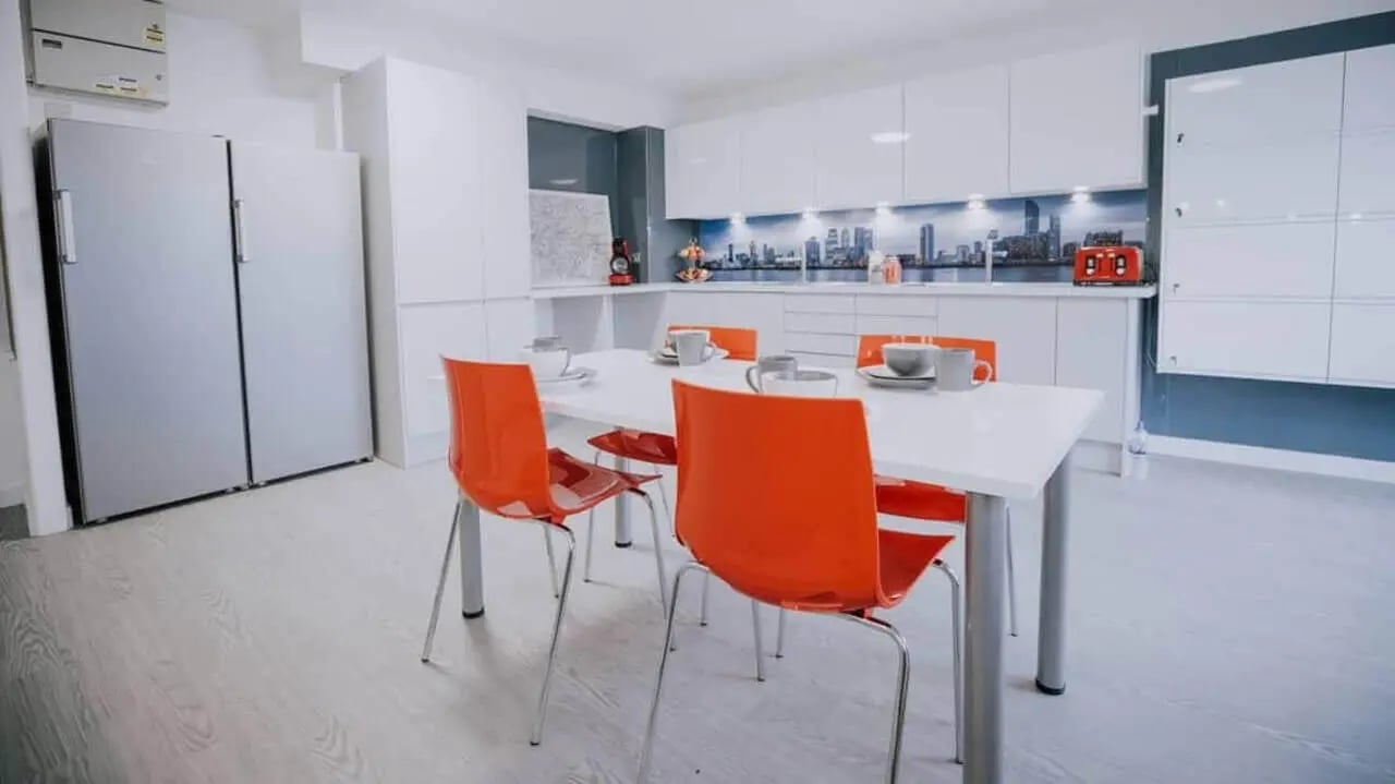 Table chairs refrigerators modern kitchen island kitchen at Manna Ash House in London Student Accommodation