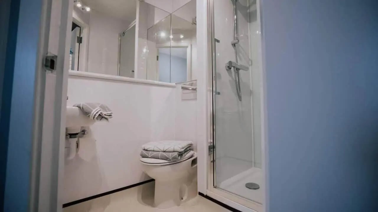 Sink toilet shower cabin mirror bathroom at Manna Ash House in London Student Accommodation