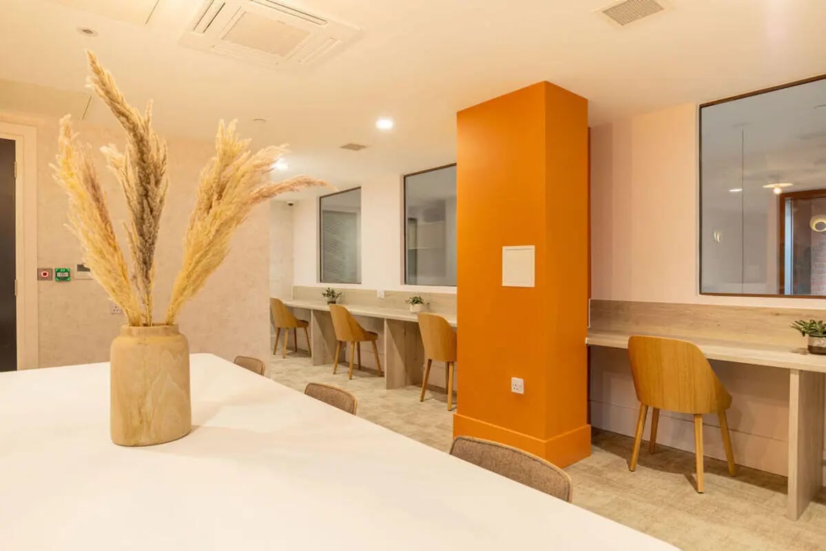 Pampas grass in vase long tables chairs study area at Yugo Crown Place in Birmingham Student Accommodation