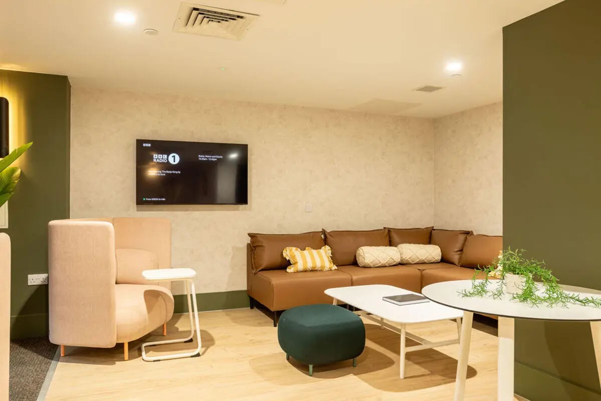 Brown sectional sofa television modern living room at Yugo Crown Place in Birmingham Student Accommodation