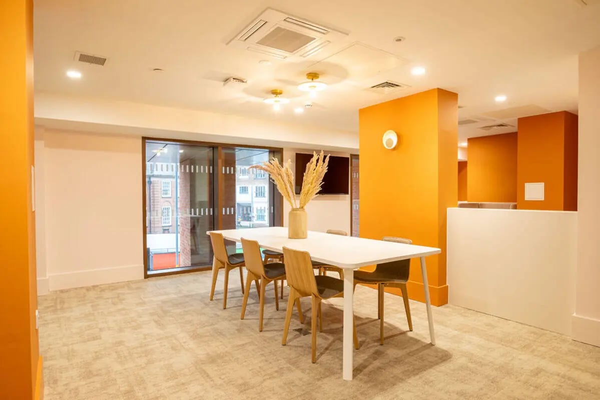 Dining table with chairs and vase common area at Yugo Crown Place in Birmingham Student Accommodation