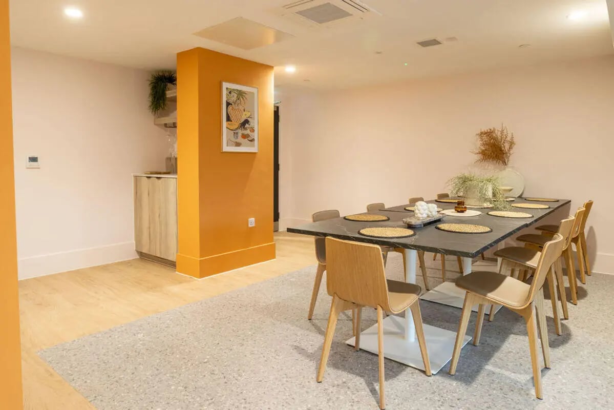 Dining table with chairs and kitchen counter dining area at Yugo Crown Place in Birmingham Student Accommodation