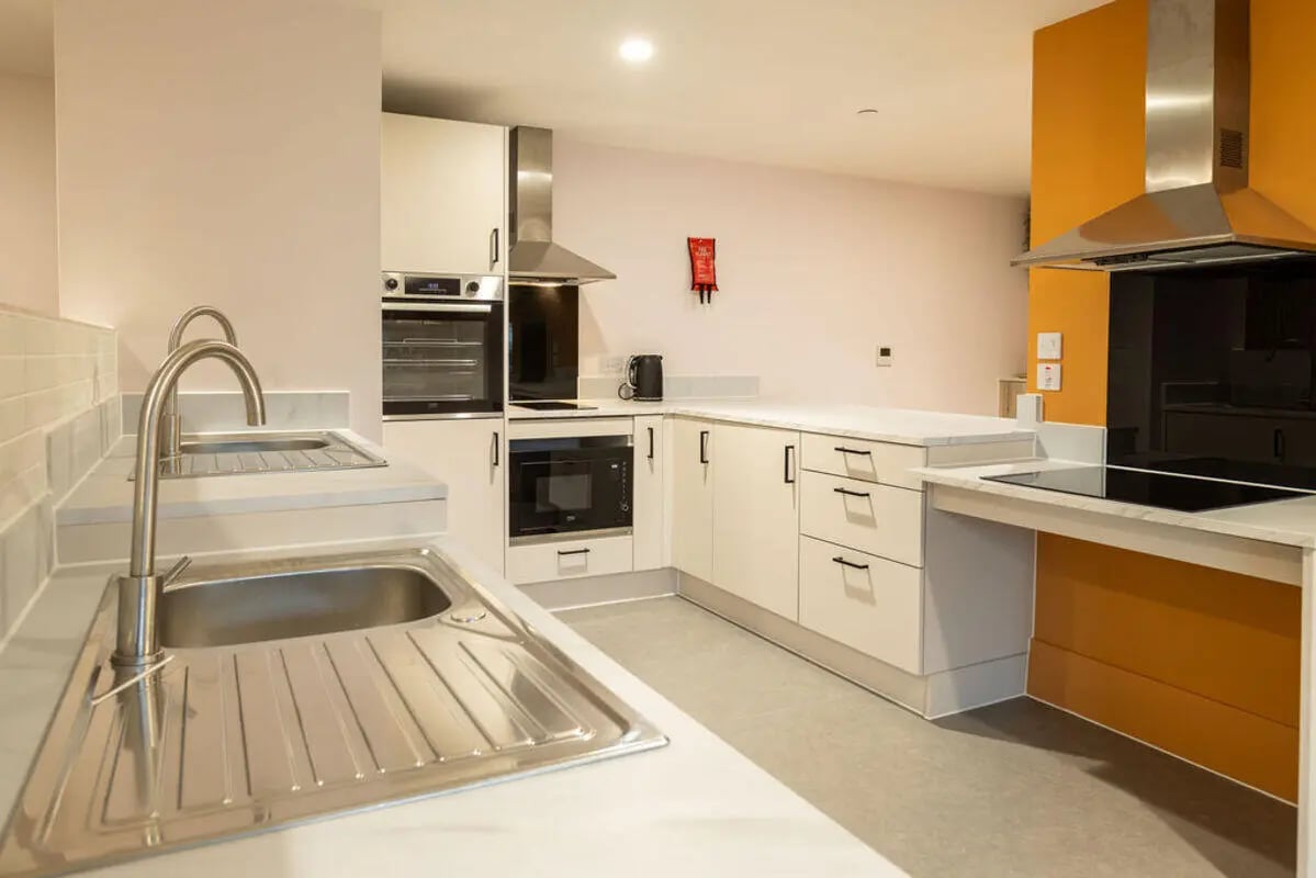 Modern kitchen with white cabinets oven microwave kitchen at Yugo Crown Place in Birmingham Student Accommodation