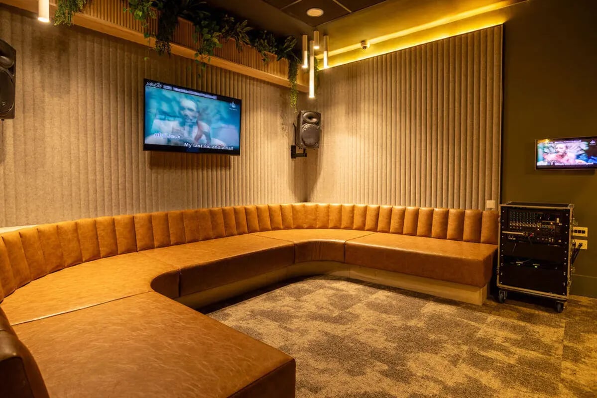 Brown sectional couch and TV playing area at Yugo Crown Place in Birmingham Student Accommodation