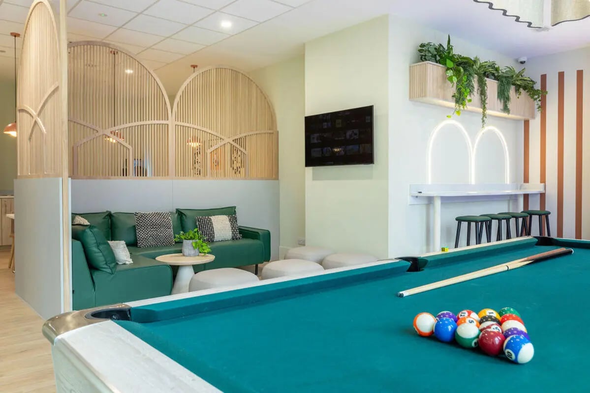 Pool table sofa and bar stools lounge area at Yugo Crown Place in Birmingham Student Accommodation