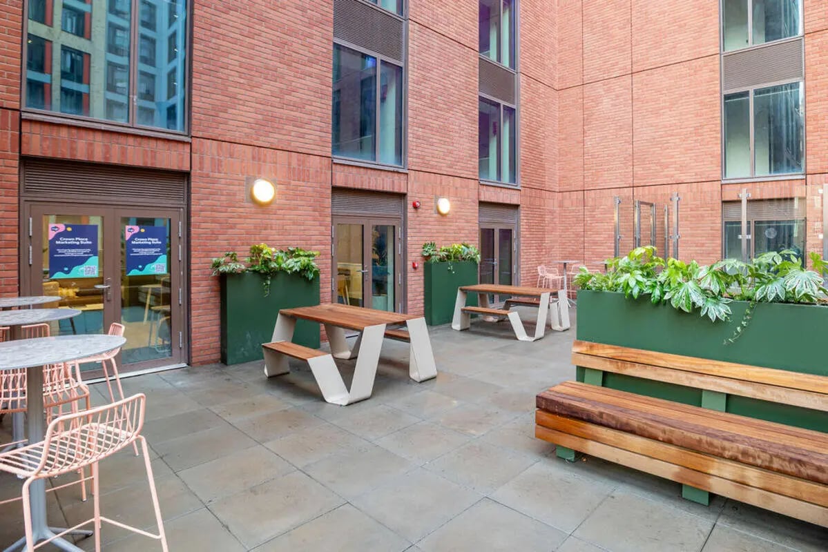 Tables benches plants exterior at Yugo Crown Place in Birmingham Student Accommodation