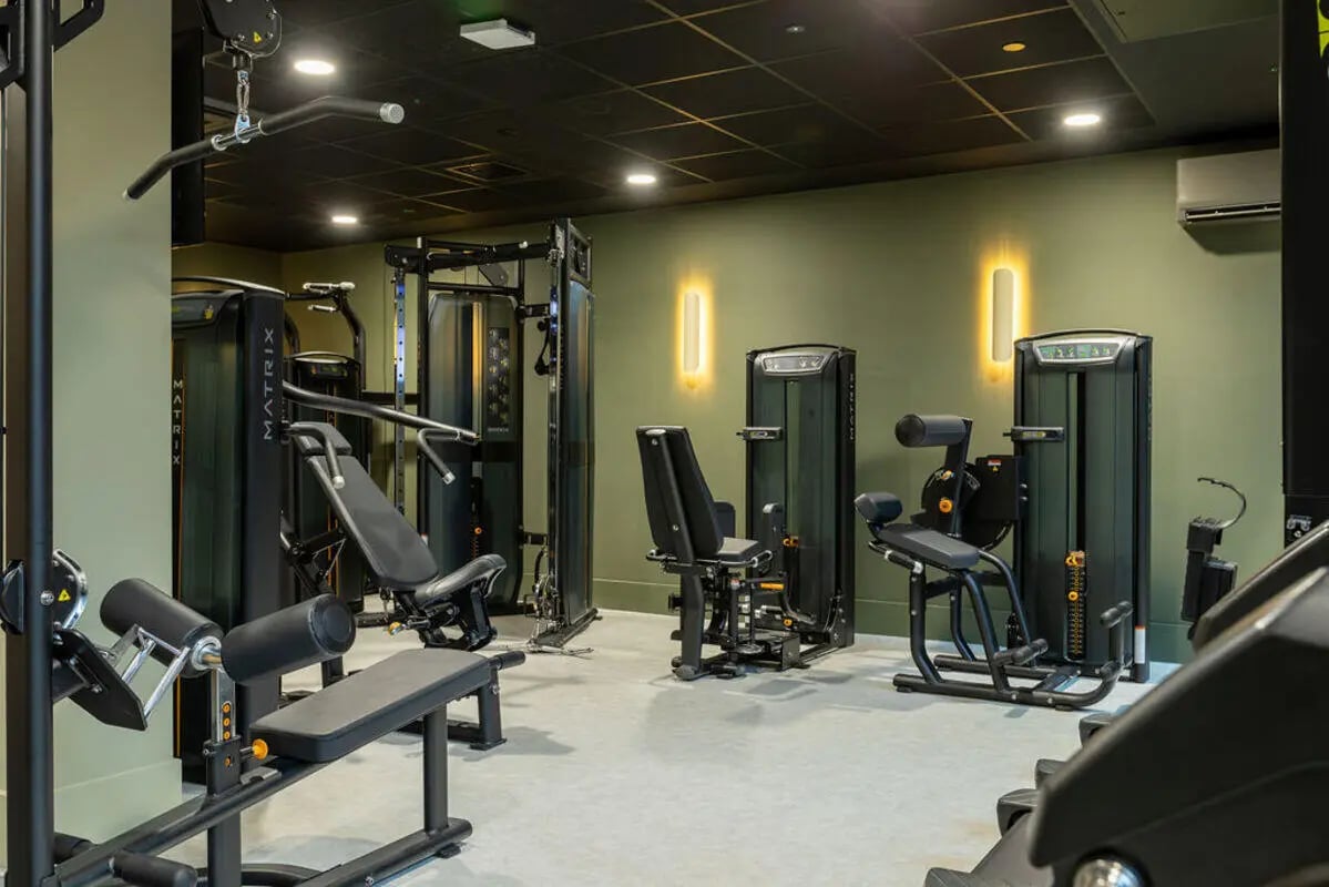 Gym equipment with benches and weight machines gym at Yugo Crown Place in Birmingham Student Accommodation