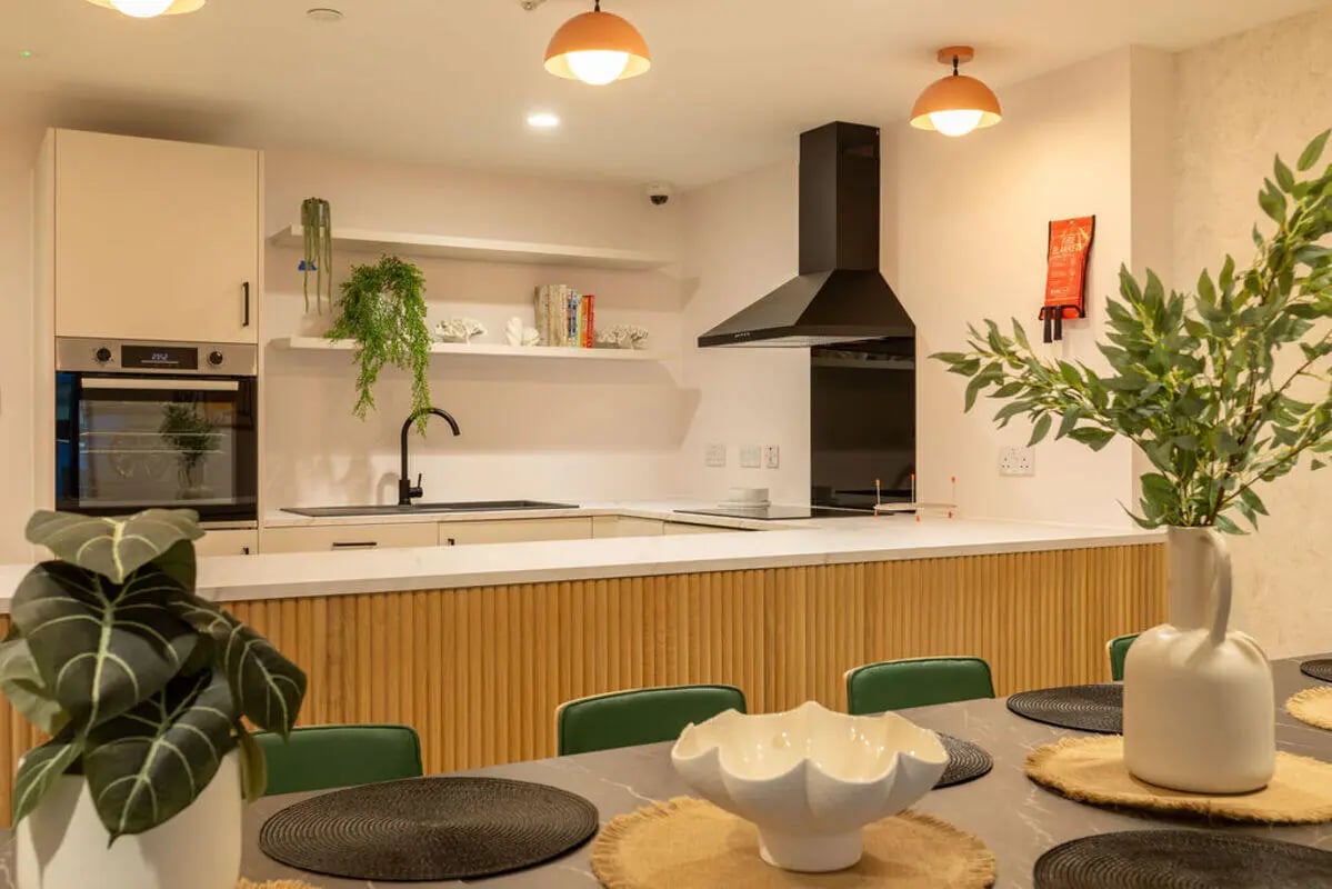 Oven sink range hood dining table kitchen at Yugo Crown Place in Birmingham Student Accommodation