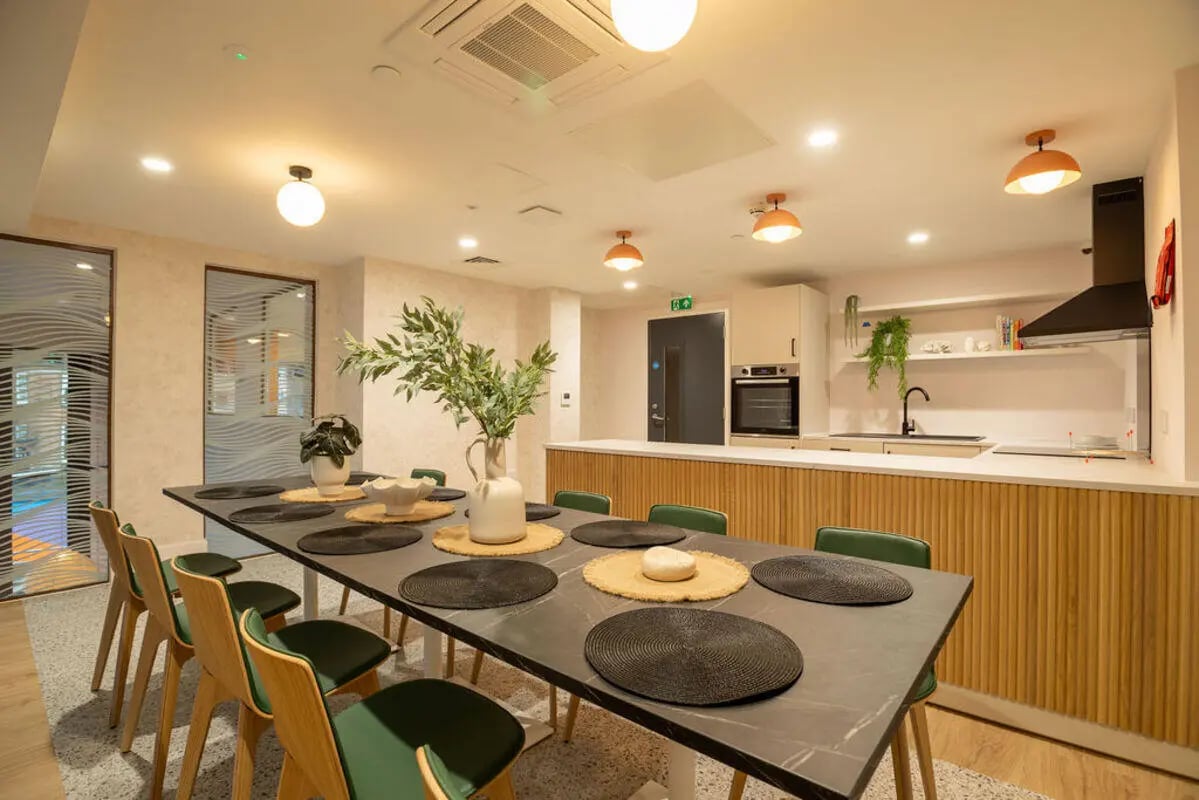 Dining table kitchen with oven sink chairs living room at Yugo Crown Place in Birmingham Student Accommodation