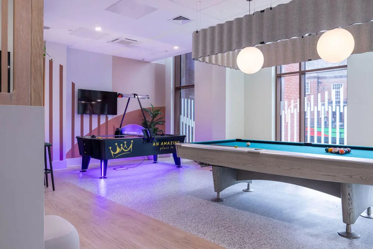 Pool and air hockey tables with balls living room at Yugo Crown Place in Birmingham Student Accommodation
