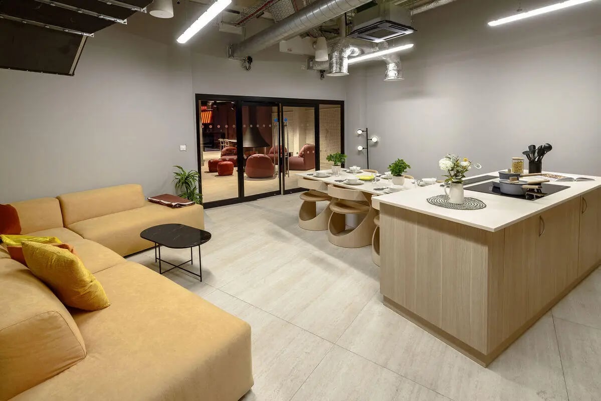 Sofa dining table kitchen island appliances shared lounge kitchen at True Nottingham in Nottingham Student Accommodation