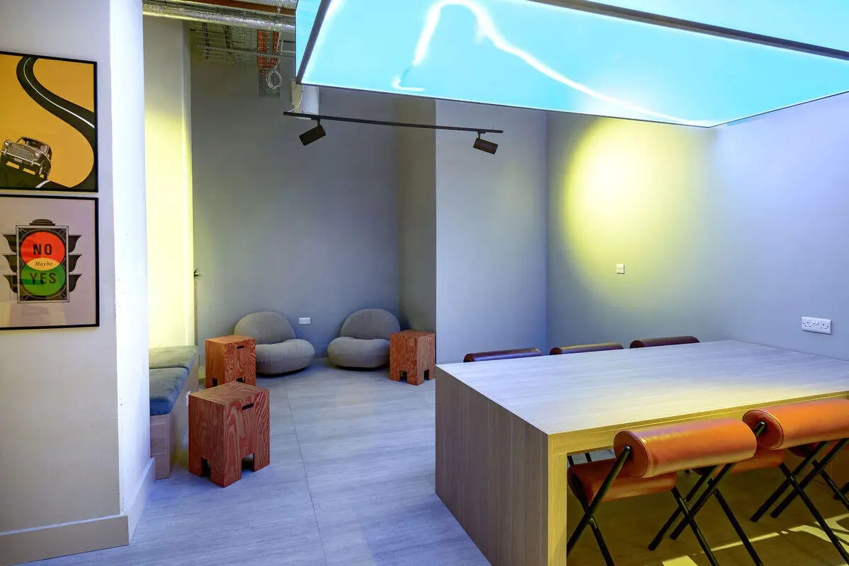 Table chairs stools beanbags art prints common area at True Nottingham in Nottingham Student Accommodation