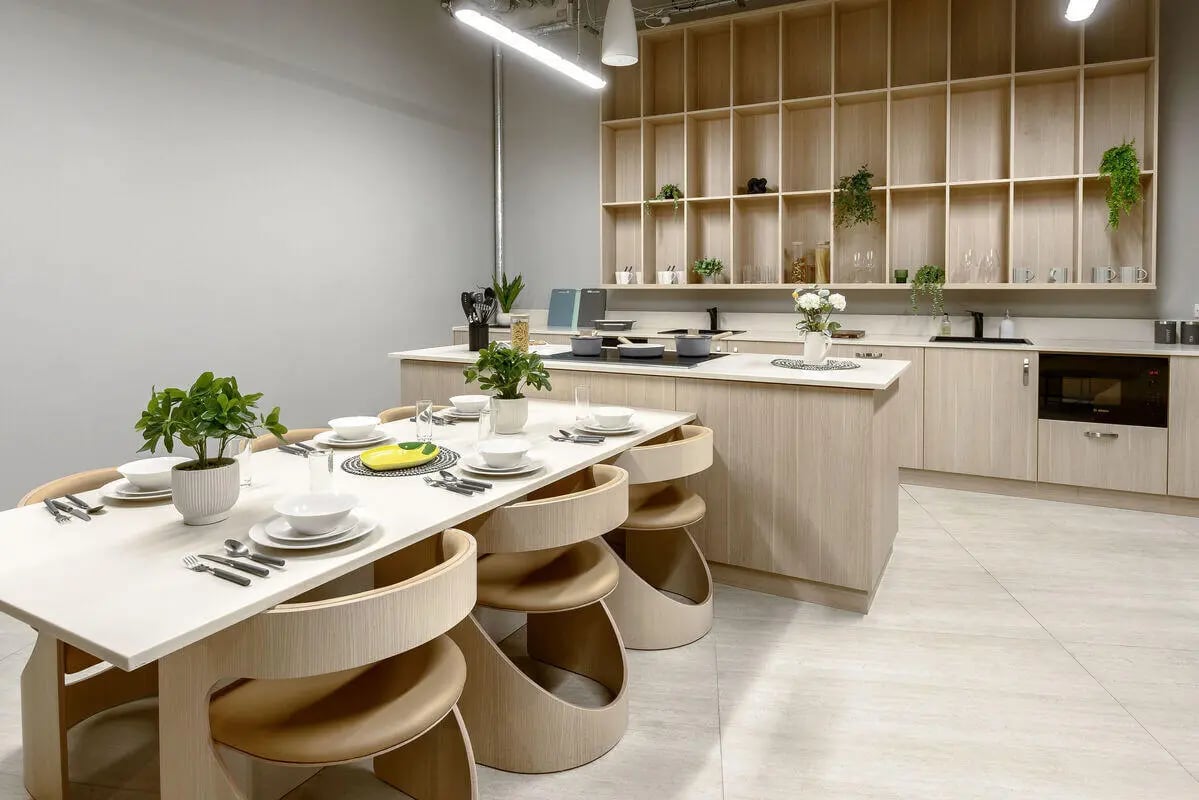 Dining table with place settings and kitchen area kitchen at True Nottingham in Nottingham Student Accommodation