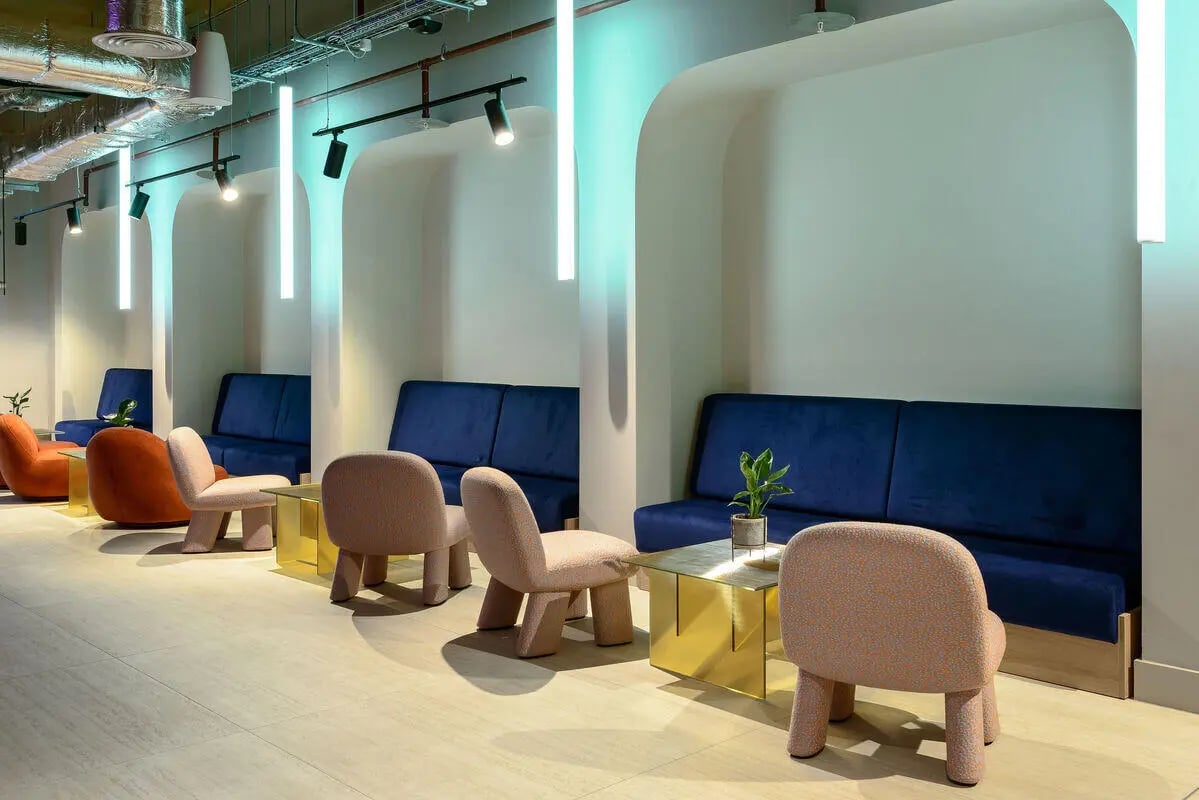 Blue sofas, chairs, and gold tables Lounge at True Nottingham in Nottingham Student Accommodation