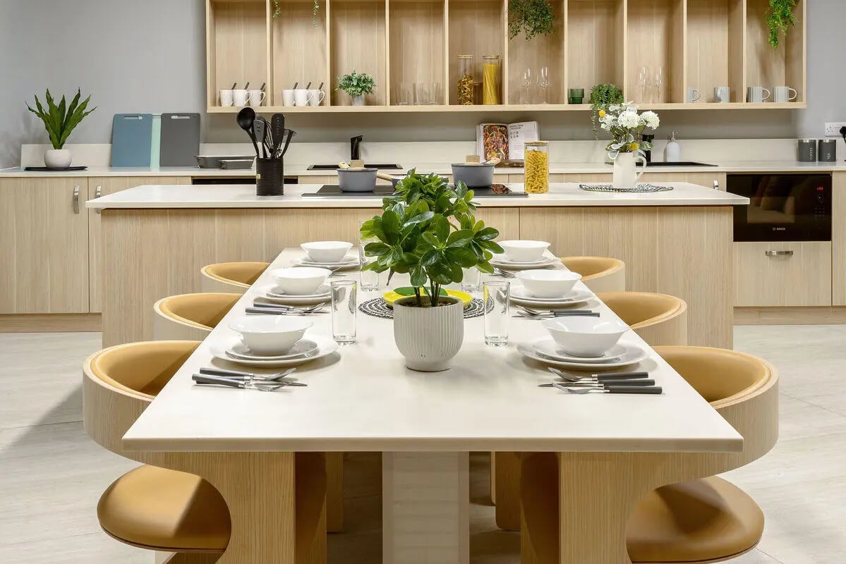 Dining table place settings plant and kitchen counter kitchen at True Nottingham in Nottingham Student Accommodation