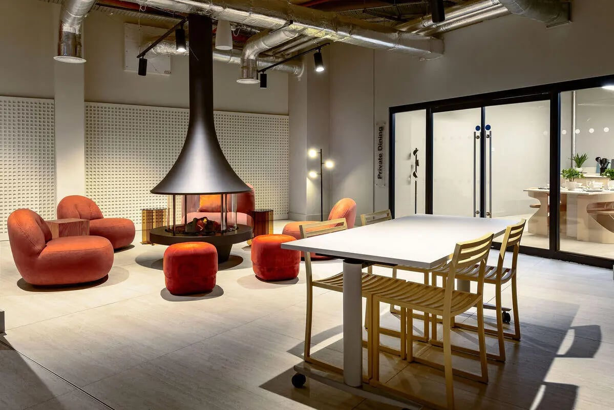 Modern lounge area with fireplace seating and dining table lounge area at True Nottingham in Nottingham Student Accommodation